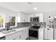 Modern kitchen features stainless steel appliances and white shaker cabinets at 4251 Tangerine Ave, Sanford, FL 32773