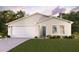 Single-story home with two-car garage and landscaped front yard at 429 Baltic Ct, Poinciana, FL 34759