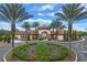 Community entrance with circular drive and landscaping at 5240 Oakbourne Ave, Davenport, FL 33837