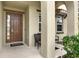 Covered front porch with seating and decorative landscaping at 5240 Oakbourne Ave, Davenport, FL 33837