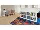 Convenient study area with built-in shelving and a playful rug at 5240 Oakbourne Ave, Davenport, FL 33837