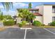 Front view of condo with landscaping, parking, and pergola at 4100 Player Cir # 101, Orlando, FL 32808