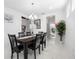 Bright dining room with a large table, chandelier, and access to the kitchen at 791 Terrapin Dr, Debary, FL 32713