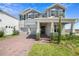 Two story home with gray siding, brick accents, and a covered porch at 791 Terrapin Dr, Debary, FL 32713