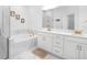 Spa-like bathroom featuring a soaking tub, double vanity, and a frameless shower at 791 Terrapin Dr, Debary, FL 32713