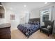 Main bedroom with a king-size bed, a large window, and an ensuite bathroom at 791 Terrapin Dr, Debary, FL 32713