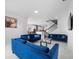 Open living room showcasing blue velvet sofas and a view into the kitchen at 791 Terrapin Dr, Debary, FL 32713