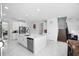 Open concept kitchen with white cabinetry, large island, and stainless steel appliances at 791 Terrapin Dr, Debary, FL 32713