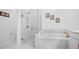 Bathroom with a walk-in shower, soaking tub, and marble tile at 791 Terrapin Dr, Debary, FL 32713