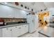 White kitchen features stainless steel appliances and ample cabinet space at 4670 Links Village Dr # D506, Ponce Inlet, FL 32127