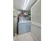 Laundry room with washer, dryer, and storage shelves at 4670 Links Village Dr # D506, Ponce Inlet, FL 32127