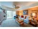 Comfortable living room featuring a sofa, recliner, and balcony access at 4670 Links Village Dr # D506, Ponce Inlet, FL 32127