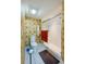 Bathroom with shower, toilet and patterned wallpaper at 4670 Links Village Dr # D506, Ponce Inlet, FL 32127