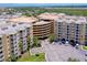 Aerial view of condo building with parking garage and surrounding area at 4670 Links Village Dr # D506, Ponce Inlet, FL 32127