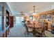 A glass-top dining table with four chairs sits in the dining area at 4670 Links Village Dr # D506, Ponce Inlet, FL 32127