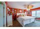 Large main bedroom with a king-size bed and orange walls at 4670 Links Village Dr # D506, Ponce Inlet, FL 32127