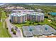 Well-maintained tennis courts situated near a condo building and lush greenery at 4670 Links Village Dr # D506, Ponce Inlet, FL 32127