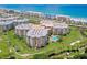 Aerial view of condo complex near the beach, showcasing its layout and surrounding landscape at 4670 Links Village Dr # D506, Ponce Inlet, FL 32127