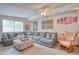 Cozy living room with sectional sofa and rocking chair, perfect for relaxation at 6269 Se 125Th Pl, Belleview, FL 34420