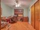 Home office with wood desk, built-in shelving, and hardwood floors at 6269 Se 125Th Pl, Belleview, FL 34420