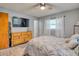 Comfortable bedroom with a dresser and large TV at 6269 Se 125Th Pl, Belleview, FL 34420