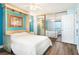Bright bedroom with a queen bed, mirrored closet doors, and ocean view at 3370 Ocean Shore Blvd # 203B, Ormond Beach, FL 32176