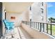 Balcony with two chairs and American flag decor, ocean view at 3370 Ocean Shore Blvd # 203B, Ormond Beach, FL 32176