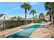 Shuffleboard court with palm trees, and residential area background at 3370 Ocean Shore Blvd # 203B, Ormond Beach, FL 32176