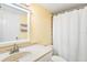 Clean bathroom with a shower/tub combo, white vanity, and yellow walls at 3370 Ocean Shore Blvd # 203B, Ormond Beach, FL 32176
