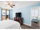 Bedroom with a queen bed, balcony access, and ocean view at 3370 Ocean Shore Blvd # 203B, Ormond Beach, FL 32176