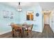 Bright dining area with a wooden table and four chairs, kitchen pass-through, and light blue walls at 3370 Ocean Shore Blvd # 203B, Ormond Beach, FL 32176