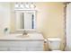 Clean bathroom with white vanity, toilet, and tiled shower at 3370 Ocean Shore Blvd # 203B, Ormond Beach, FL 32176