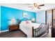Bedroom with a queen-size bed, ocean view, and light blue walls at 3370 Ocean Shore Blvd # 203B, Ormond Beach, FL 32176