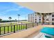 Balcony view of the ocean, palm trees, and beachfront property at 3370 Ocean Shore Blvd # 203B, Ormond Beach, FL 32176