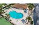 Aerial view of kidney-shaped community pool with surrounding lounge chairs at 3370 Ocean Shore Blvd # 203B, Ormond Beach, FL 32176