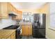 Kitchen with granite countertops, modern appliances, and wood cabinets at 3370 Ocean Shore Blvd # 203B, Ormond Beach, FL 32176