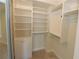Spacious walk-in closet with built-in shelves and hanging rods at 231 Riverside Dr # 2409-1, Holly Hill, FL 32117