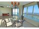 Bright dining area with glass table and water views at 231 Riverside Dr # 2409-1, Holly Hill, FL 32117