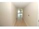 Long hallway with light wood flooring, leading to living area at 231 Riverside Dr # 2409-1, Holly Hill, FL 32117