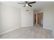 Bright bedroom with ceiling fan and access to bathroom at 231 Riverside Dr # 2409-1, Holly Hill, FL 32117