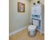 Small bathroom with toilet and storage cabinet at 3801 S Atlantic Ave # 303, Daytona Beach Shores, FL 32118