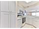 White kitchen cabinets and modern appliances at 1183 Ocean Shore Blvd # 5050, Ormond Beach, FL 32176
