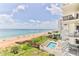 Aerial view of beach, pool, and building at 1183 Ocean Shore Blvd # 5050, Ormond Beach, FL 32176