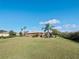 Single-story house with a large grassy yard and palm trees at 112 Sevilla Ct, Poinciana, FL 34759