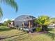 Spacious screened patio with seating area, perfect for outdoor relaxation at 112 Sevilla Ct, Poinciana, FL 34759