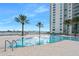 Relaxing pool area with palm trees and building view at 231 Riverside Dr # 1106-1, Holly Hill, FL 32117