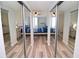 Spacious bedroom with mirrored closet doors and wood-look floors at 231 Riverside Dr # 1106-1, Holly Hill, FL 32117