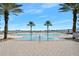 Resort-style pool with palm trees and water views at 231 Riverside Dr # 1106-1, Holly Hill, FL 32117
