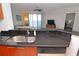 Kitchen features granite countertops and a double sink at 231 Riverside Dr # 1106-1, Holly Hill, FL 32117