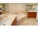 Spa-like bathroom with a corner soaking tub and double vanity at 231 Riverside Dr # 1106-1, Holly Hill, FL 32117